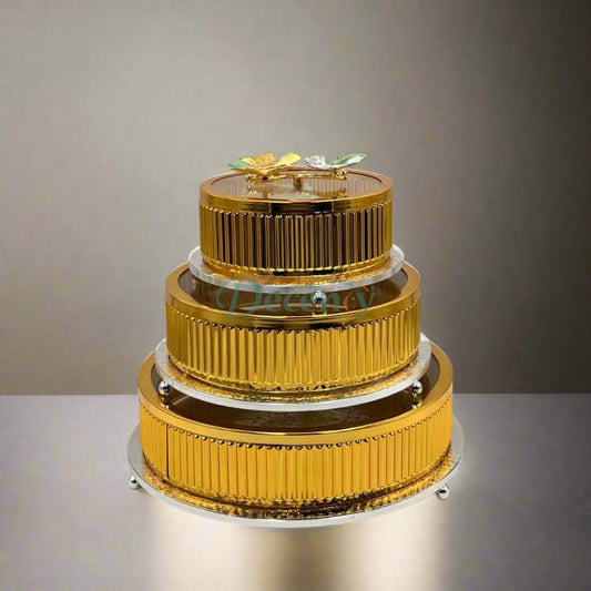 Elegant three-tier golden storage jars displayed on a sleek surface, perfect for stylish kitchen organization.