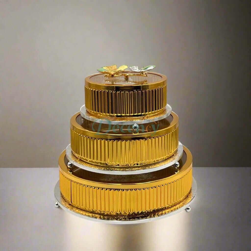 Elegant three-tier golden storage jars displayed on a sleek surface, perfect for stylish kitchen organization.