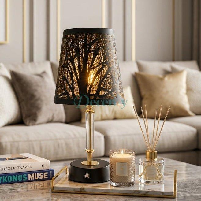 Modern black and gold cutout table lamp glowing on a marble coffee table in a modern living room