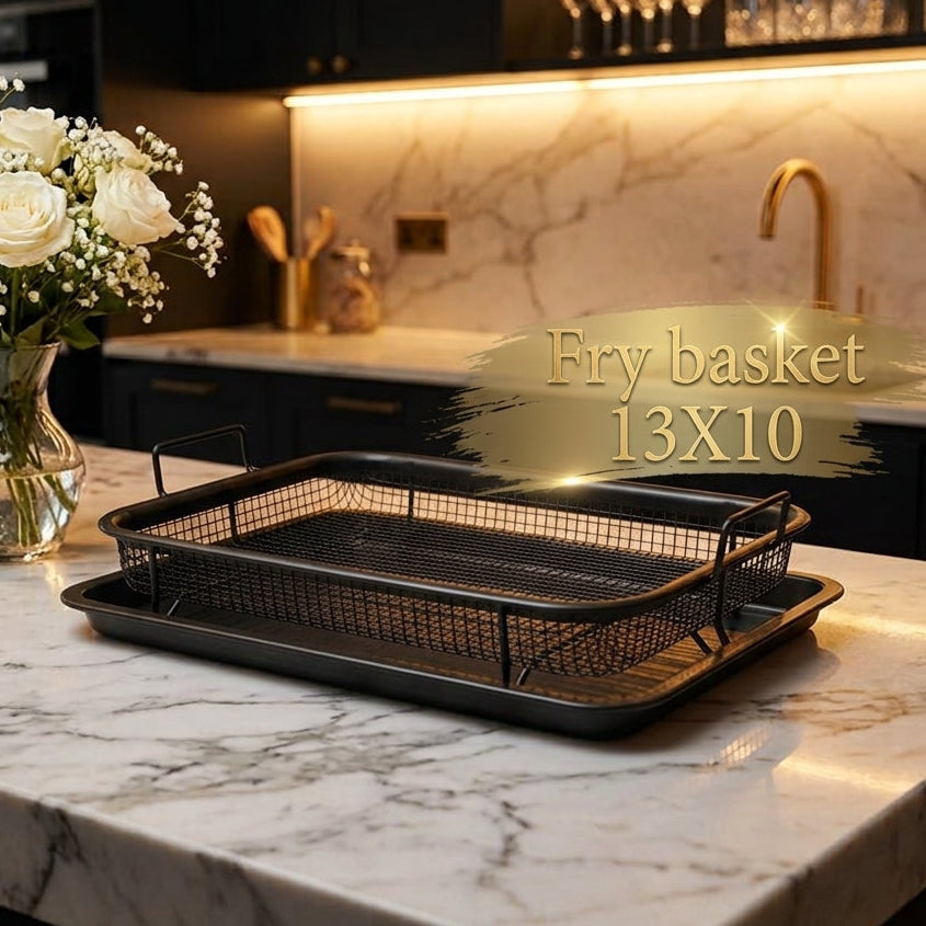 Black rectangular non-stick air fryer basket sitting inside a matching black drip tray on a marble countertop.