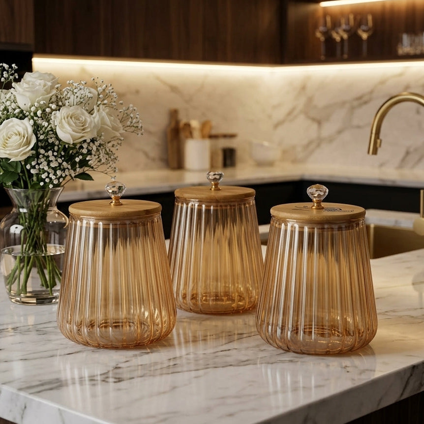 3-piece brown glass jar set with fluted ribbed design and wooden bamboo lids on a marble kitchen counter