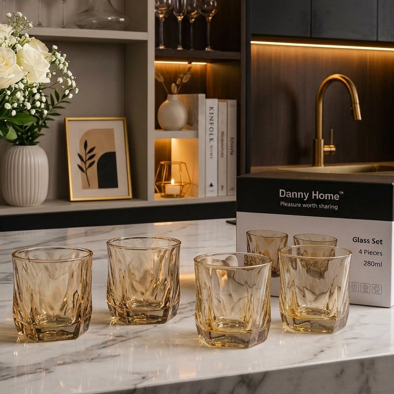 Danny Home set of 4 amber glass drinking tumblers displayed on a marble kitchen counter