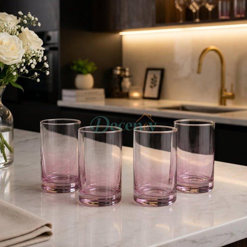 Elegant 4-piece pink gradient glass tumbler set displayed on a marble countertop