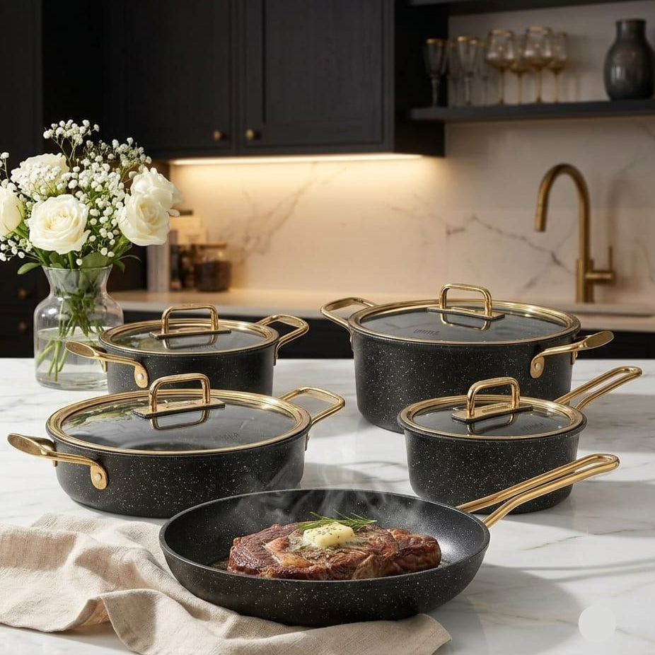 Falez black and gold granite cookware set arranged on a kitchen counter