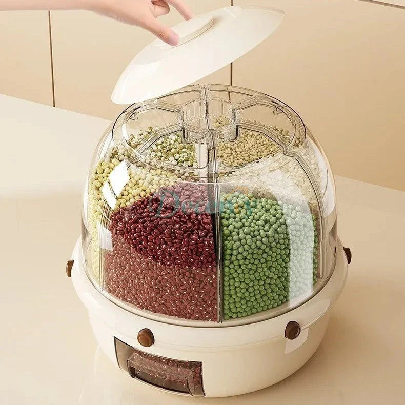 Kitchen appliance with a removable top cover displaying grains inside, on a neutral background.