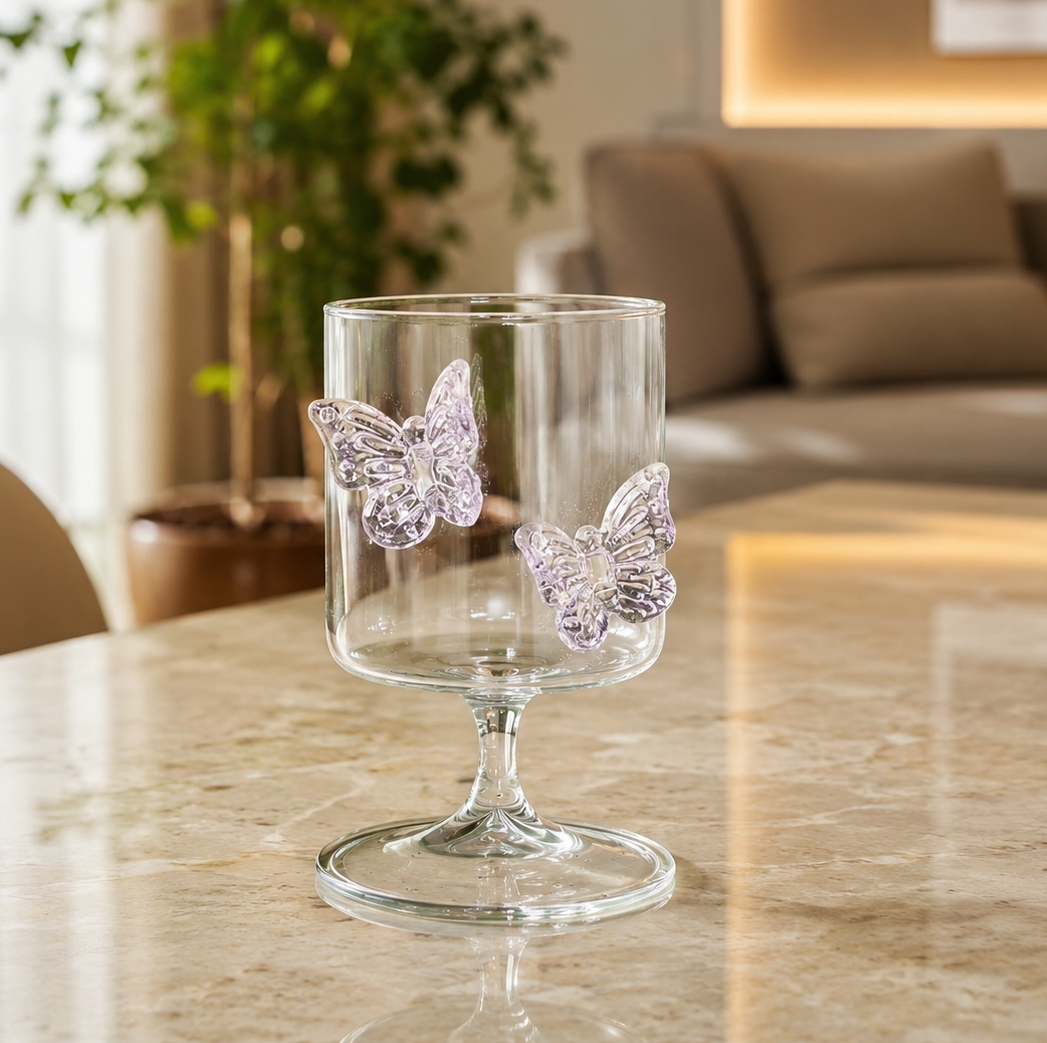 Lavender butterfly glass goblet with clear body standing on a dining table