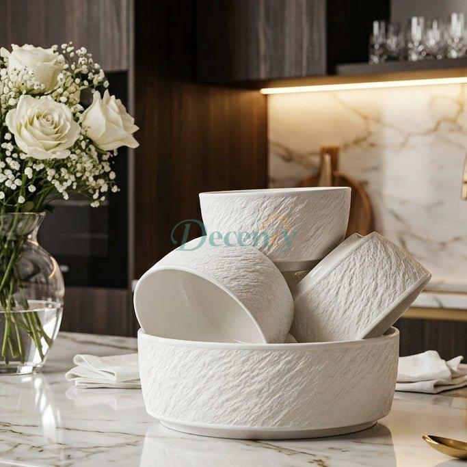 Stacked white embossed ceramic soup bowls with large serving bowl