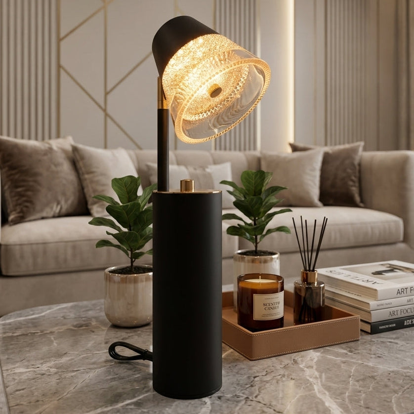 Modern black and gold table lamp with textured glass shade on a marble table in a luxury living room.
