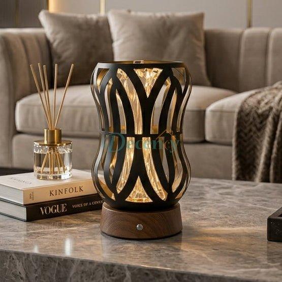 Modern black metal cage table lamp sitting on a marble coffee table in a modern Pakistani living room setup.