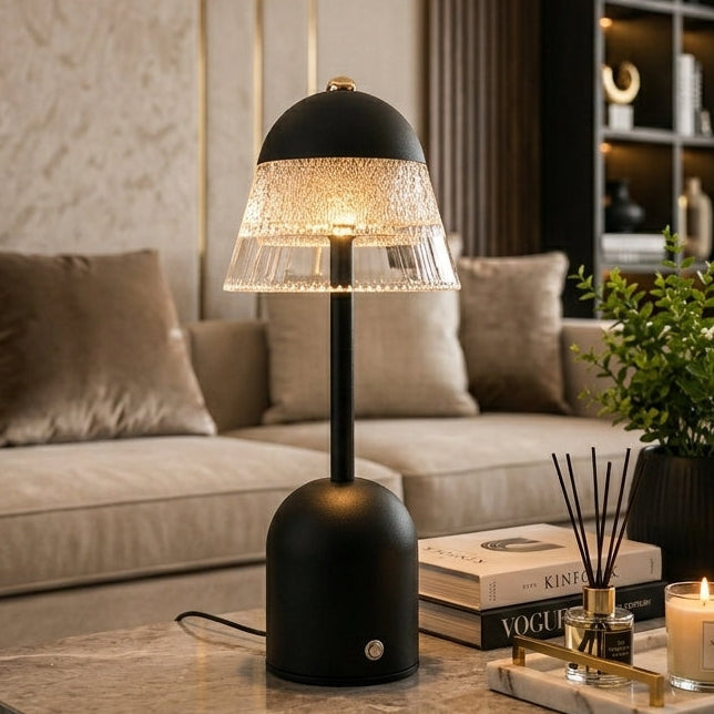 Black rechargeable crystal dome table lamp illuminated on a coffee table in a modern living room setup.