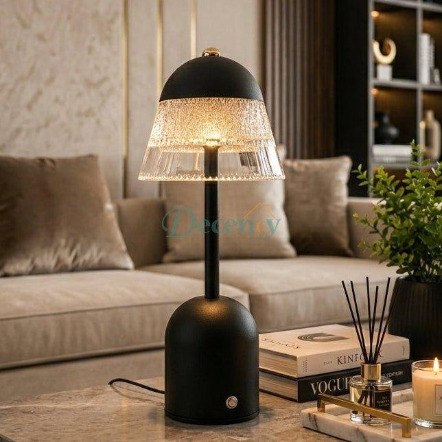 Black rechargeable crystal dome table lamp illuminated on a coffee table in a modern living room setup.