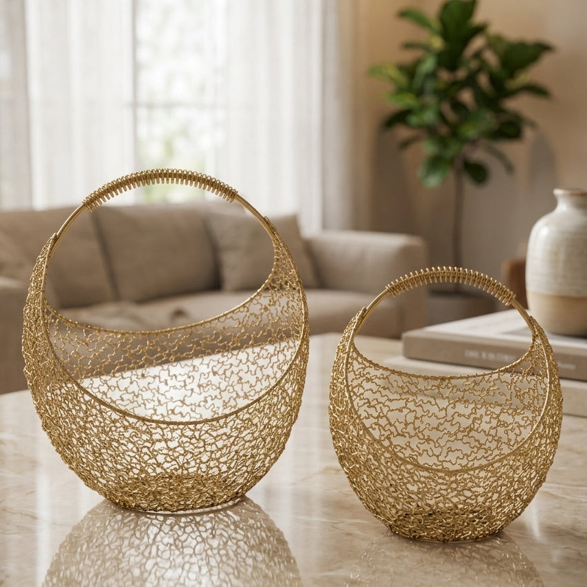 2 pcs gold wire mesh fruit basket set displayed on a marble coffee table in a modern living room.