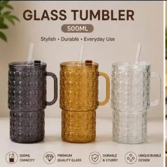 Aesthetic 500ml clear glass tumbler with a bubble design, sturdy handle, lid, and reusable straw for cold drinks.