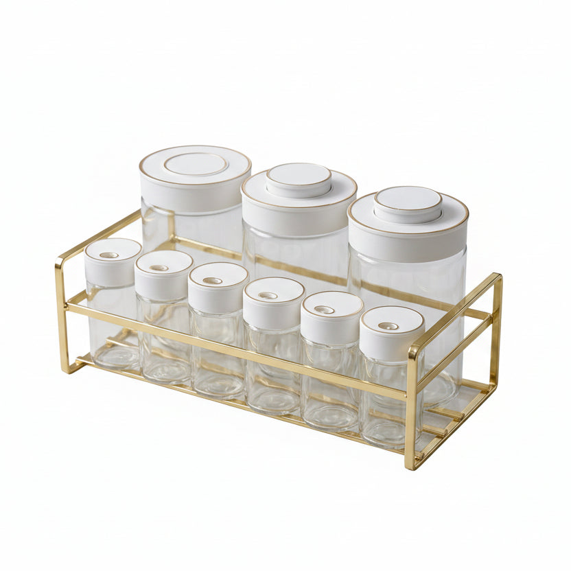 9-piece glass spice jar set arranged neatly on a gold metal rack in a modern kitchen.