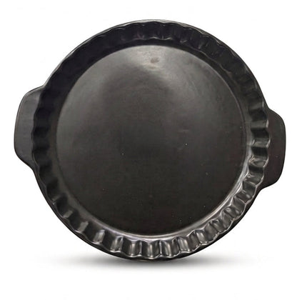 Top view of a matte black round ceramic tart mold with side handles.