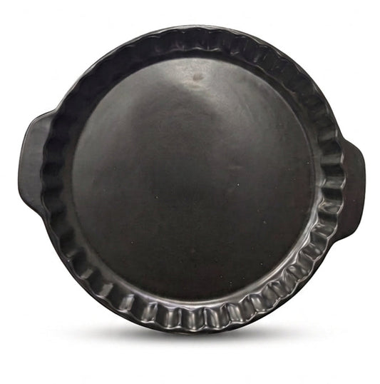Top view of a matte black round ceramic tart mold with side handles.