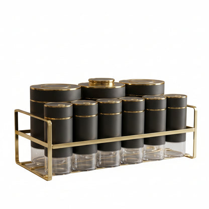 Luxury matte black and gold spice jar set with metal stand on a marble countertop