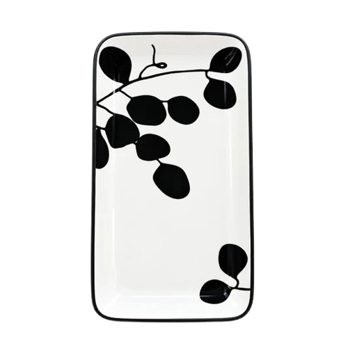 Top-down view of a rectangular ceramic serving tray featuring a black leaf and branch pattern on a white background.   