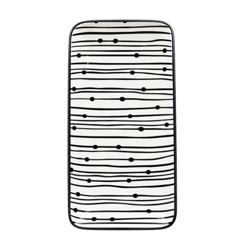 Top view of a rectangular black and white striped ceramic serving platter with graphic dot patterns against a white background