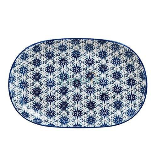 Top-down view of an oval blue starburst geometric ceramic serving platter against a clean white background.