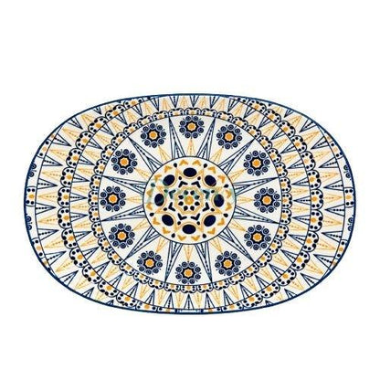 Top view of an oval ceramic serving platter with intricate blue and mustard yellow mandala geometric art.
