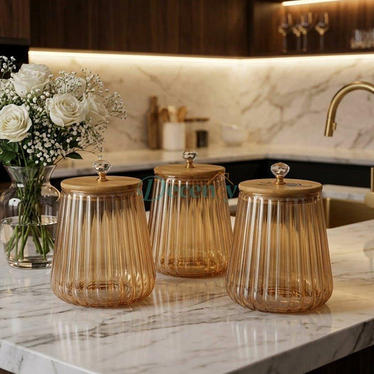 3-piece brown glass jar set with fluted ribbed design and wooden bamboo lids on a marble kitchen counter