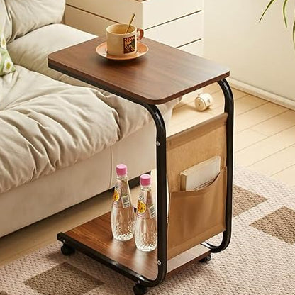 Modern C-shaped end table with wheels next to a living room sofa in a Pakistani home.