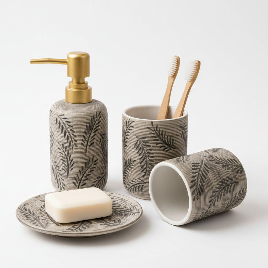 4-piece ceramic bathroom accessories set featuring a white marble finish and a luxury gold soap dispenser pump.