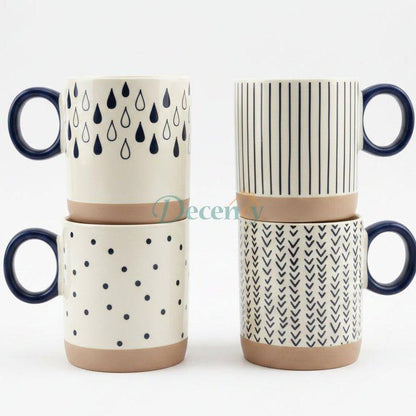 Set of 4 ceramic coffee mugs with geometric prints displayed on a kitchen marble countertop.