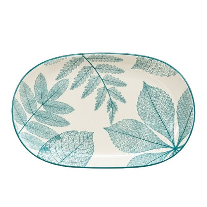 Top view of oval ceramic serving platter with green botanical leaf design