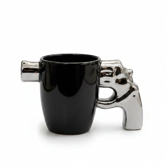 Premium ceramic revolver mug with a shiny metallic pistol grip handle on a white marble surface.
