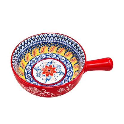 Red ceramic soup bowl with handle and hand-painted floral design on a marble dining table