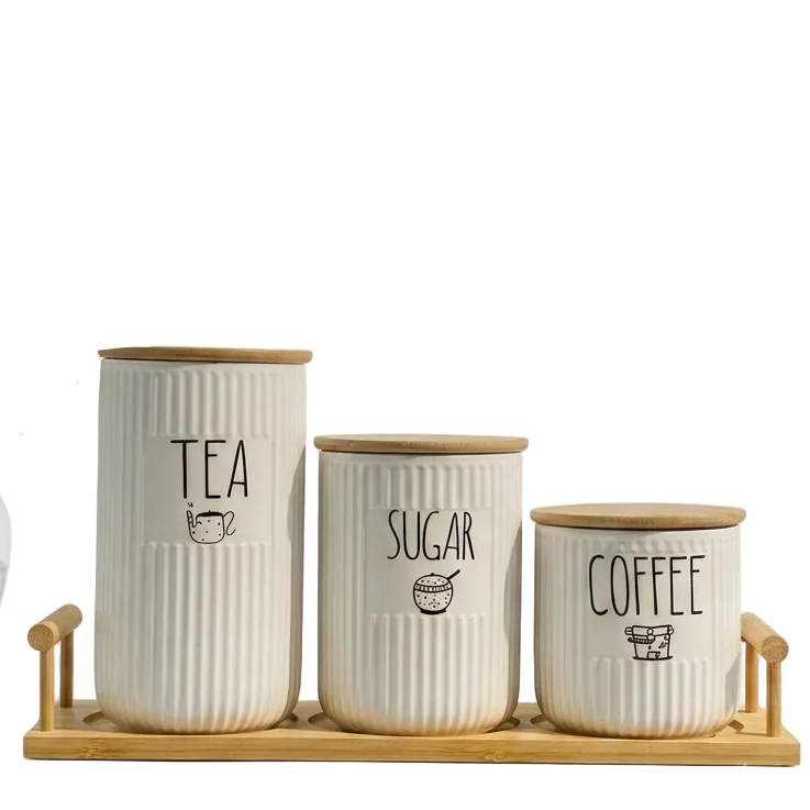 3-piece ribbed ceramic tea coffee sugar jar set placed on a wooden tray on a marble kitchen counter
