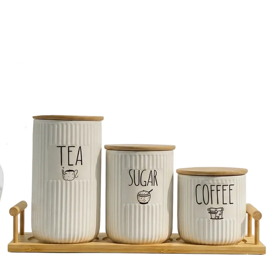 3-piece ribbed ceramic tea coffee sugar jar set placed on a wooden tray on a marble kitchen counter
