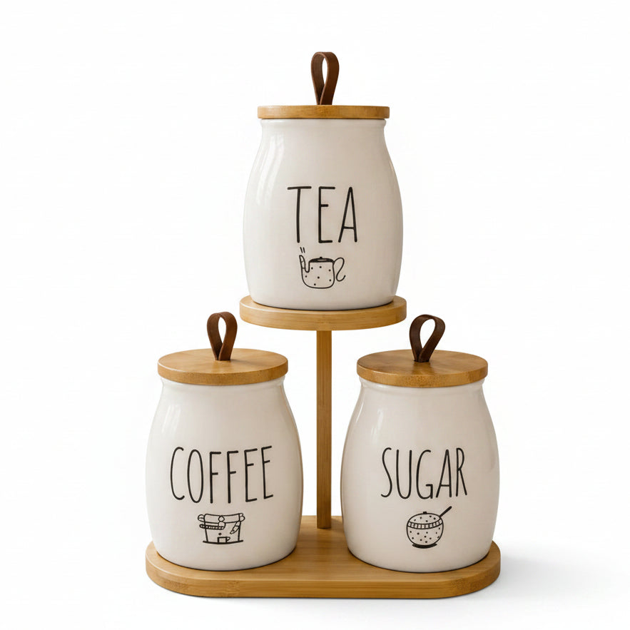 3-piece white ceramic tea, coffee, and sugar jar set on a 2-tier wooden stand on a marble countertop