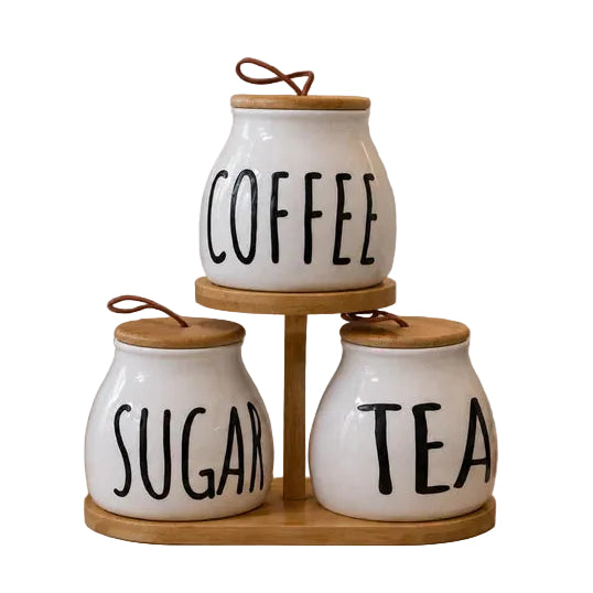3 piece white ceramic tea sugar coffee jar set arranged on a two tier wooden stand