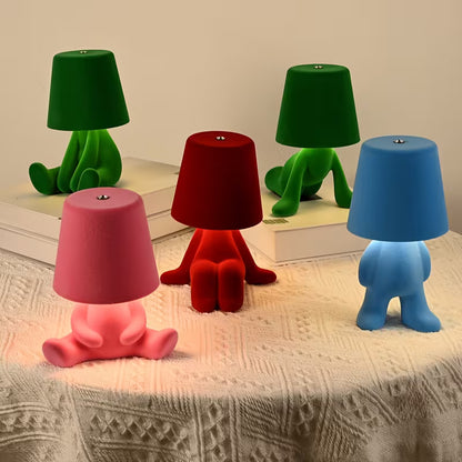 Set of colorful table lamps on a textured surface with a neutral background