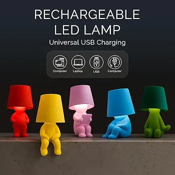 Five small rechargeable LED character lamps in red, yellow, pink, blue, and green are lined up on a shelf against a dark background, with text above reading 'RECHARGEABLE LED LAMP' and icons for computer, laptop, USB, and computer connectivity.