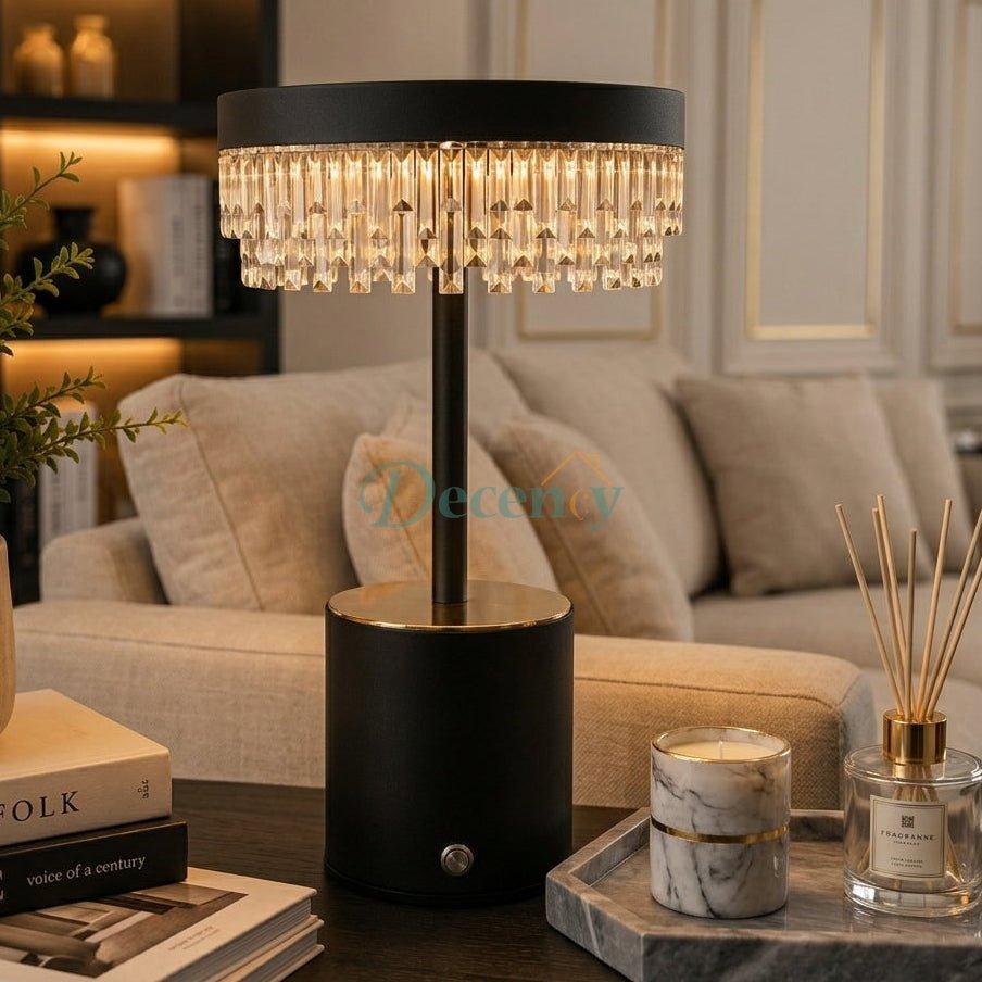 Crystal Cascade LED table lamp lit up on a living room coffee table next to decorative accents