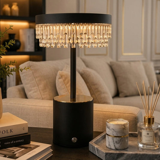 Crystal Cascade LED table lamp lit up on a living room coffee table next to decorative accents