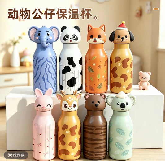 Eight cute animal-shaped insulated water bottles displayed on white blocks in a warm indoor setting. The bottles feature different animal designs including an elephant, panda, fox, dog, rabbit, deer, bear, and koala, each with unique patterns and colors.