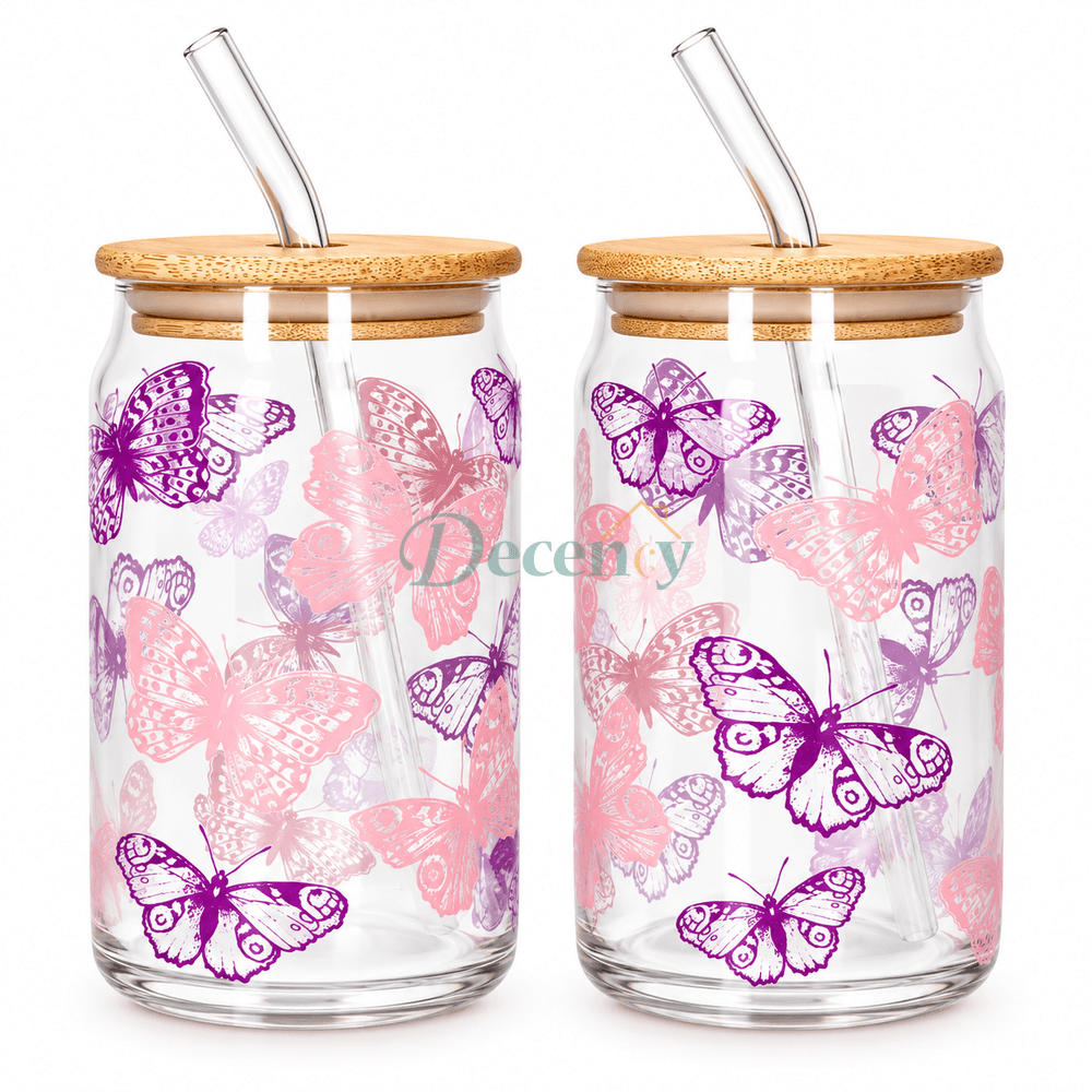 Danmy Home 2 pcs aesthetic butterfly print glass can tumbler set with bamboo lids and glass straws placed on a dining table.