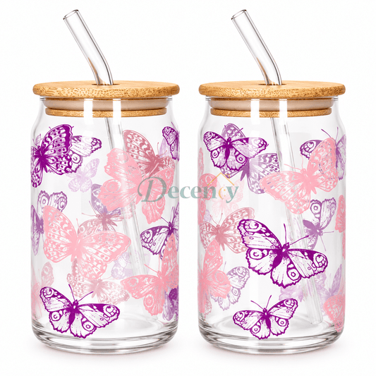 Danmy Home 2 pcs aesthetic butterfly print glass can tumbler set with bamboo lids and glass straws placed on a dining table.