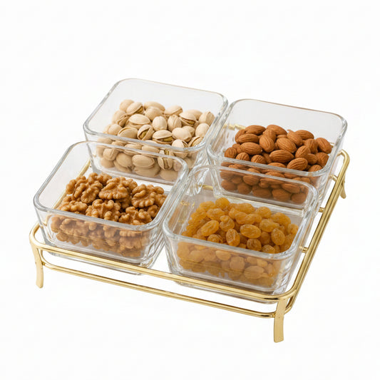 Danny Home 4-section square clear glass snack bowl set resting on a stylish gold metal stand filled with assorted dry fruits.