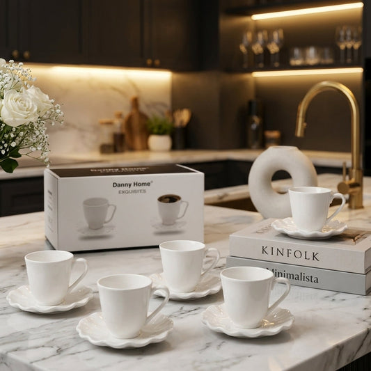 Danny Home 6-piece white ceramic 200ml cup and saucer set with scalloped edges on a marble countertop.