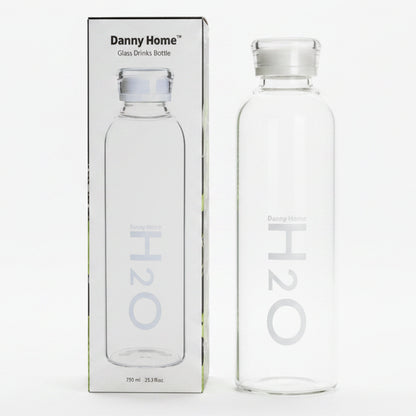 Danny Home 750ml glass water bottle placed on a modern Pakistani kitchen counter.