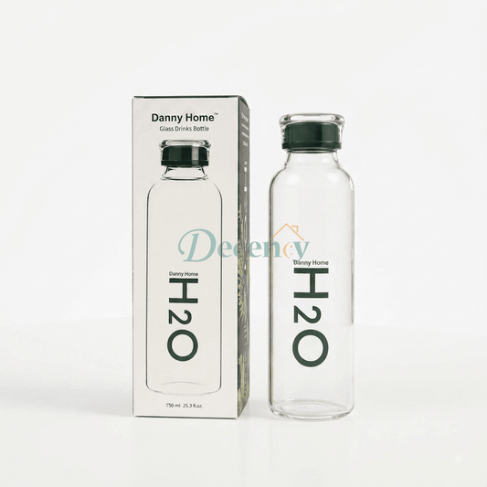 Danny Home 750ml clear glass water bottle with green H2O logo standing next to its original packaging on a kitchen marble counter.