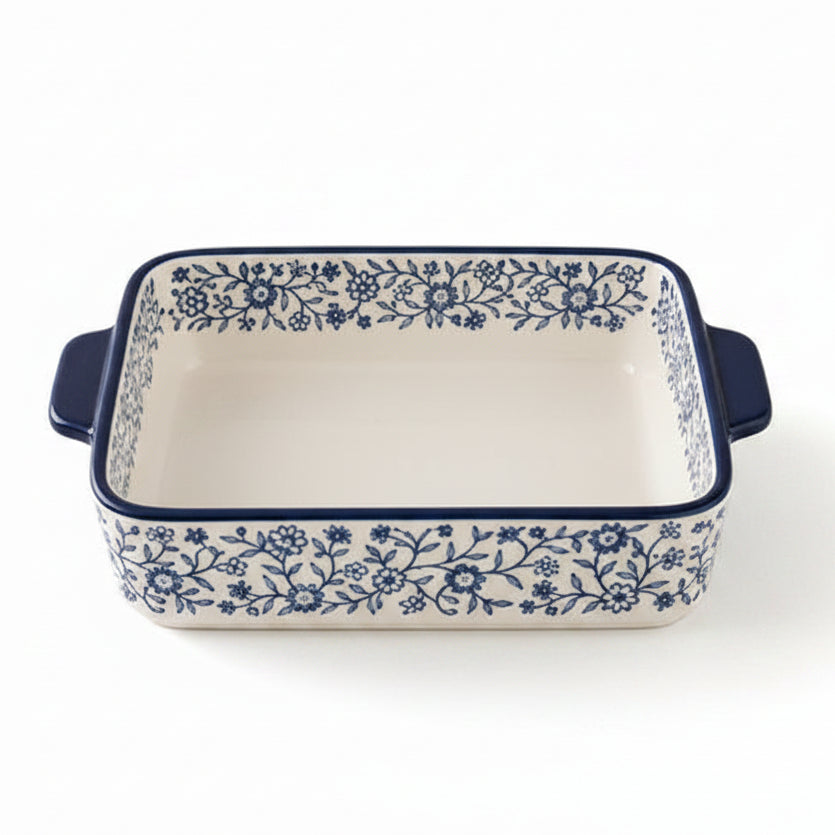 Danny Home 8 inch porcelain baking dish with blue floral pattern placed on a marble kitchen counter.