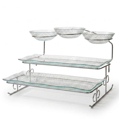 Danny Home multi-tiered clear glass serving tray and bowl stand set on a marble kitchen island.
