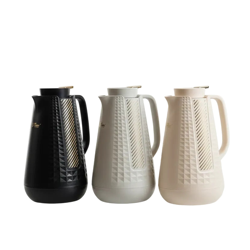 Three Day Days 1 litre vacuum flasks in black, off-white, and beige placed on a kitchen counter